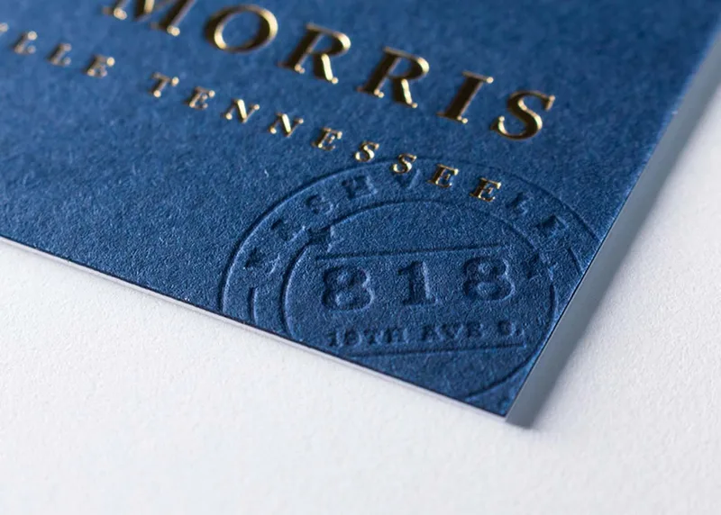 Close-up of a blind deboss impression pressed into thick cotton paper