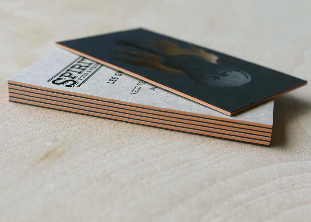 Close-up of copper foil stamping on black cotton paper