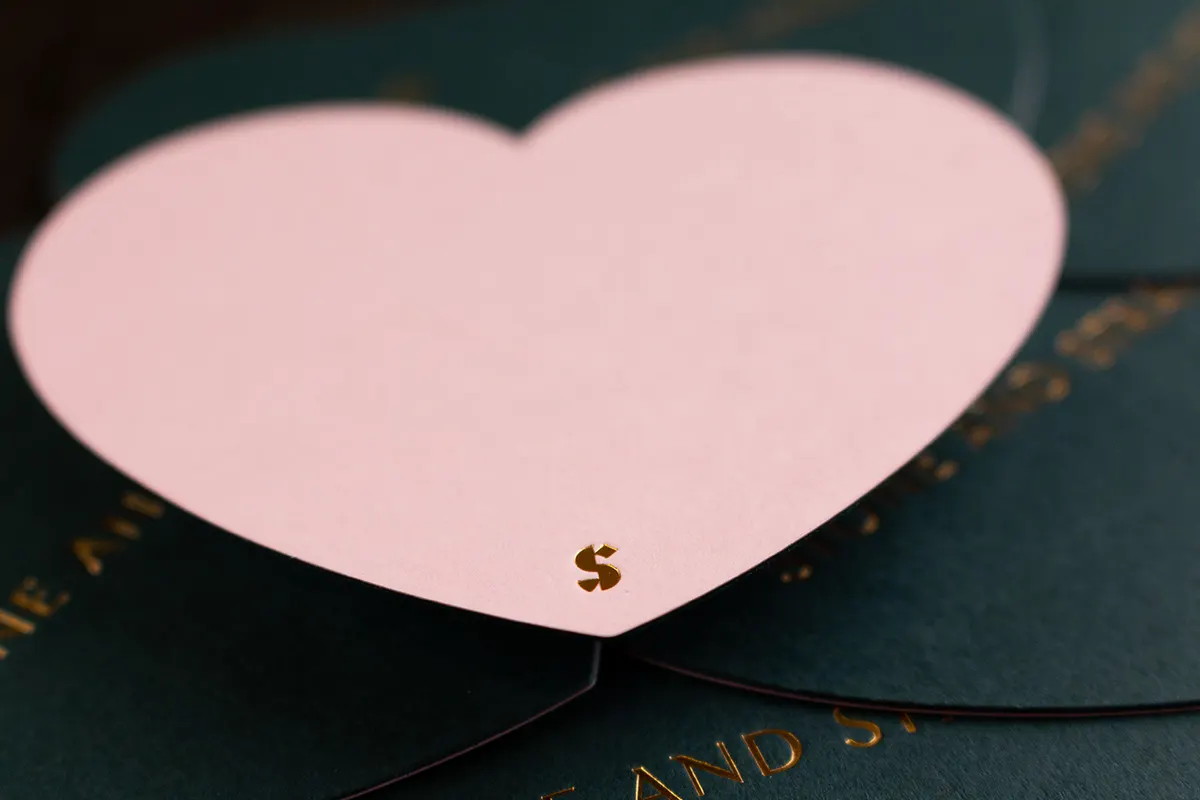 Close-up of gold foil stamping on textured cotton paper