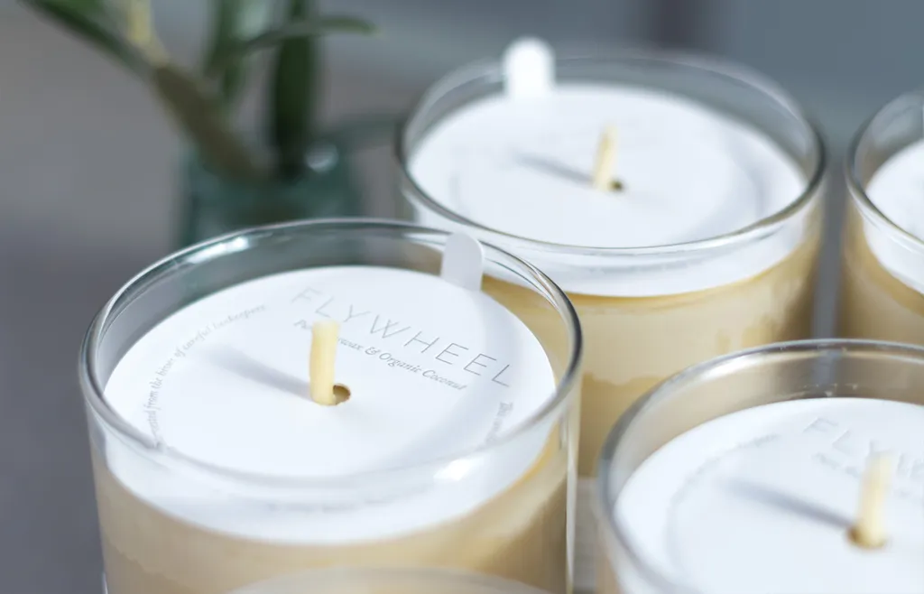 Foil-stamped letterpress candle dust covers resting on candles