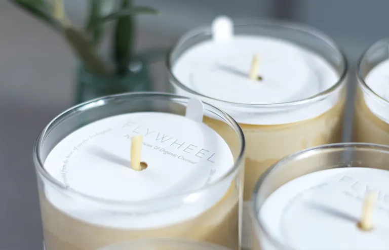 Foil-stamped letterpress candle dust covers resting on candles