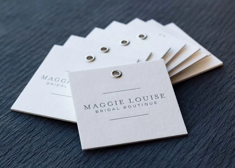 Letterpress printed hang tag with brass eyelet, hung from twine
