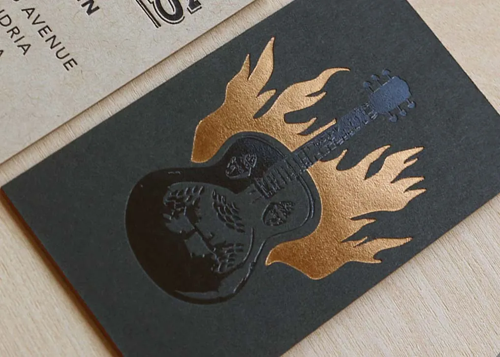 Edge view of triplexed business card showing orange French Poptone inner sheet between layers