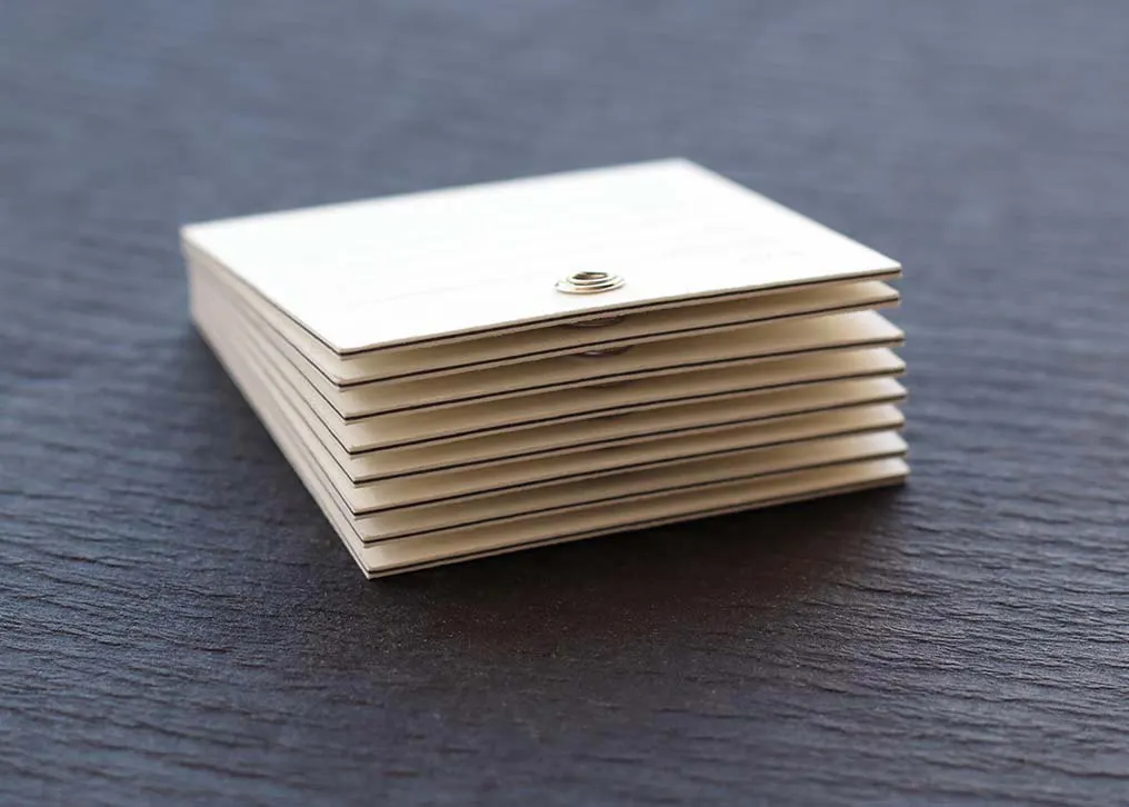 Close-up of light grey letterpress printing on textured cotton paper